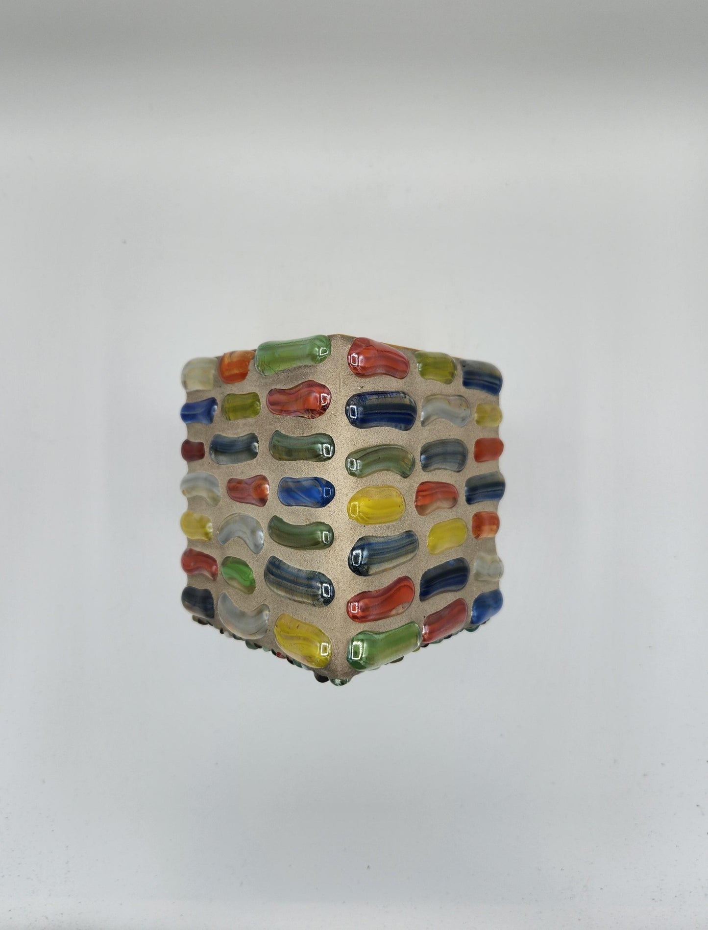 Stone and glass mosaic birdhouse.