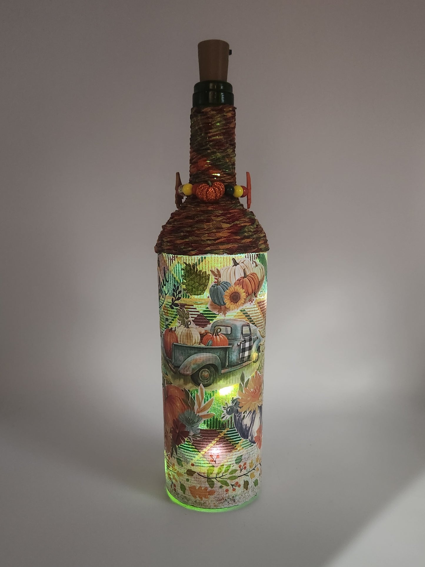 Decorative fall wine bottle with light