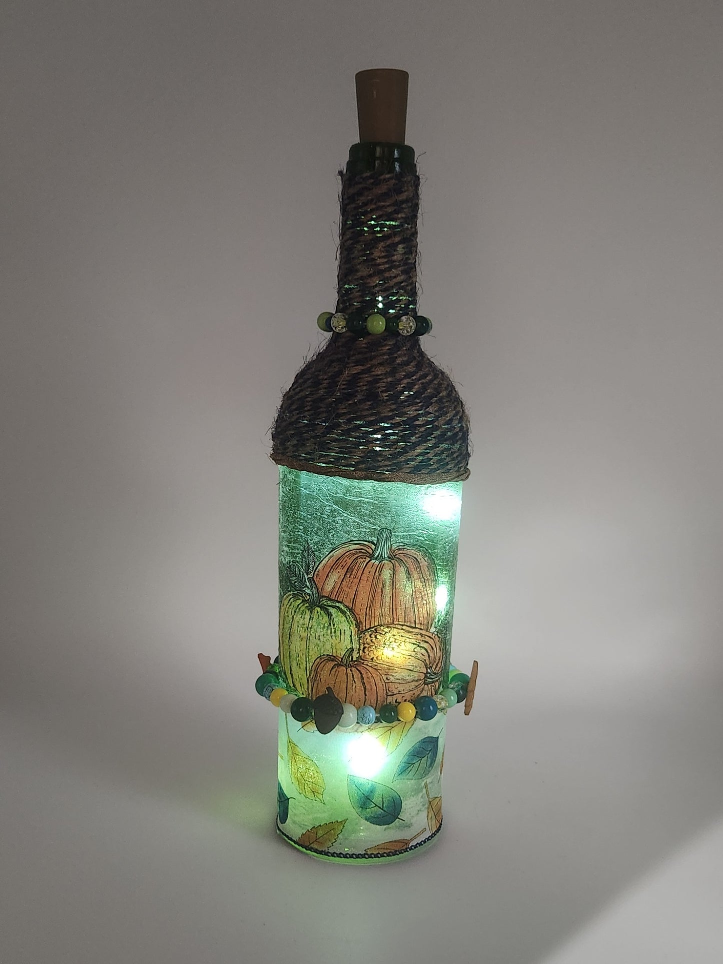 Decorative fall wine bottle with fairy lights