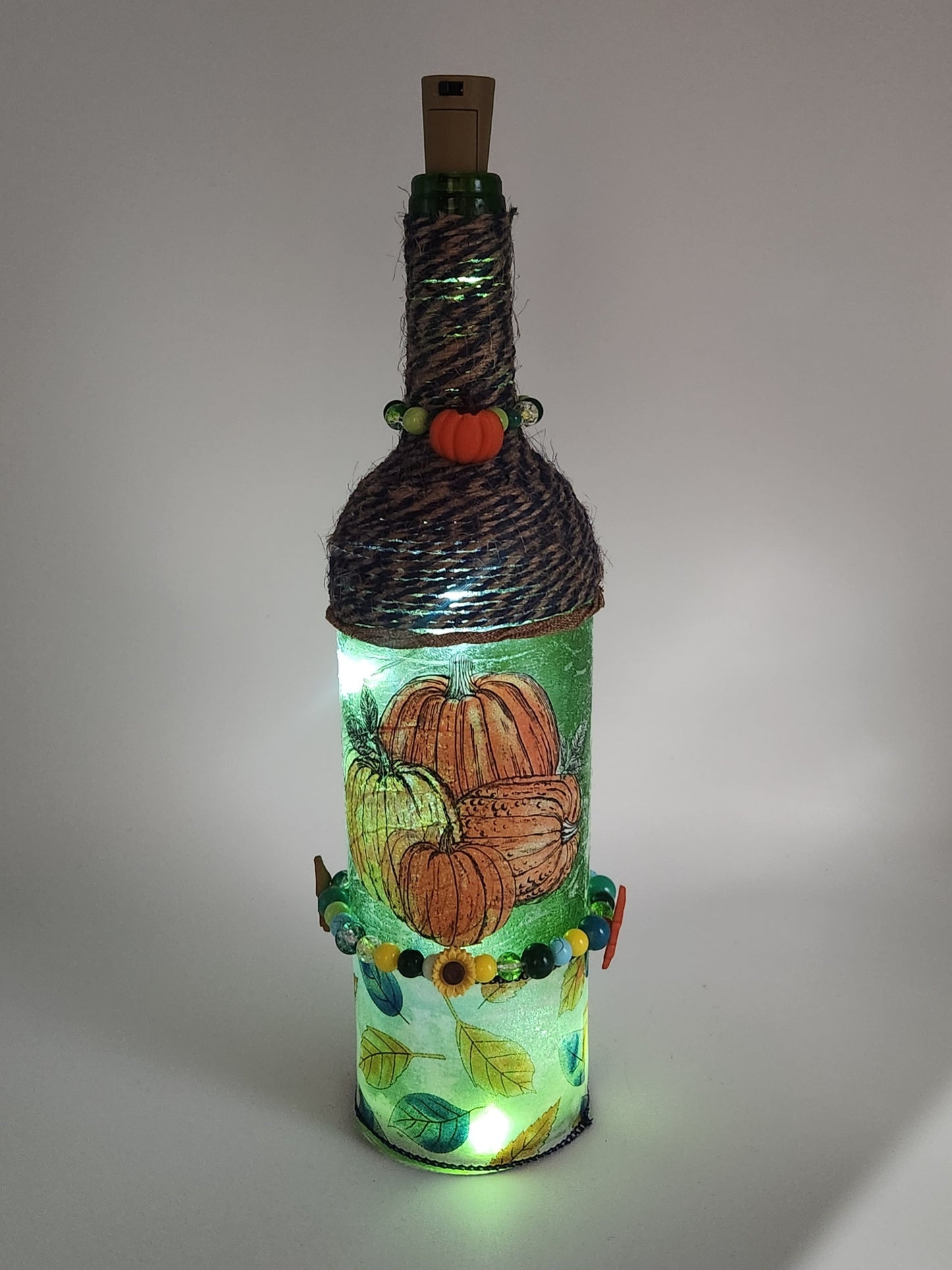 Decorative fall wine bottle with fairy lights